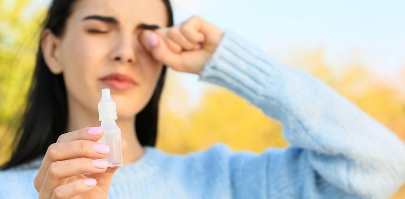 Woman with dry eyes and drops